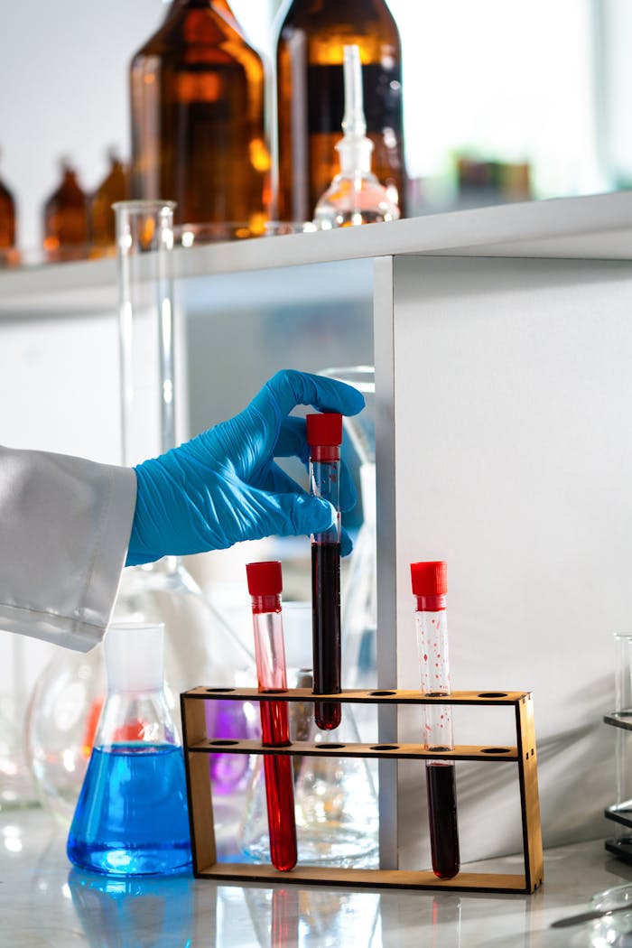 Scientist with gloves holding test tube in a modern lab setting.